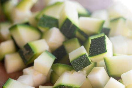 Chopped zucchini on wooden board selective focusの写真素材