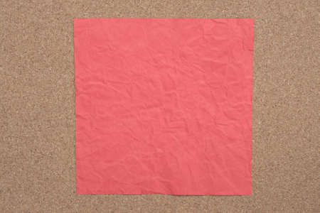 Red color creased paper note on cork backgroundの写真素材