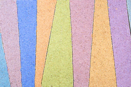 colorful stripped pattern drawing in sand backgroundの写真素材