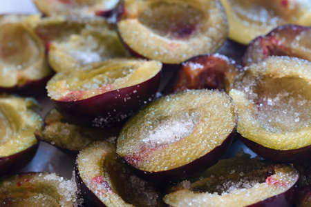 closeup to plum fruits with sugarの写真素材