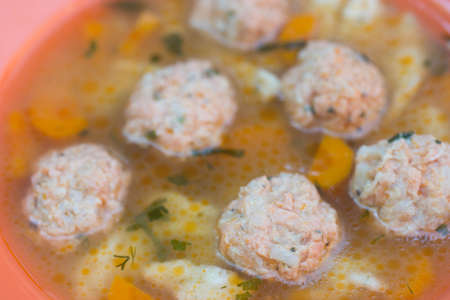 fish soup with salmon balls on plateの写真素材