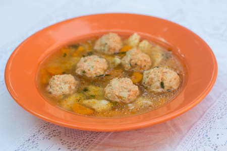 fish soup with salmon balls on plateの写真素材