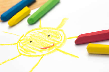 Child crayon drawing, smiling sun, selective focusの写真素材