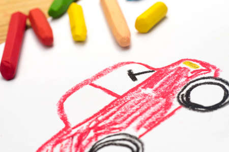 Child crayon drawing, red auto, selective focusの写真素材