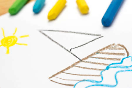 Child crayon drawing, sail boat, selective focus