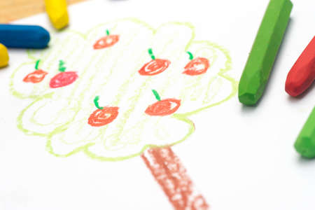 Child crayon drawing, apple tree, selective focusの写真素材
