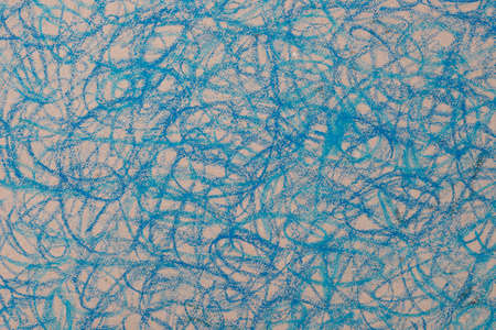 blue crayon doodles drawing on brown paper backgroundの写真素材