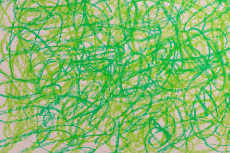 green crayon doodles drawing on brown paper backgroundの写真素材