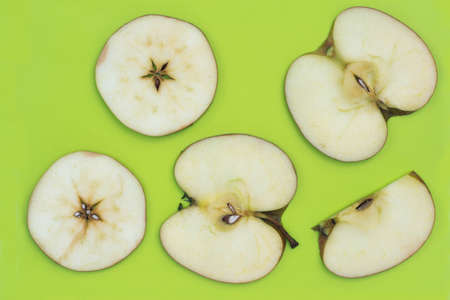 slices apple of on green plastic cutting board top view