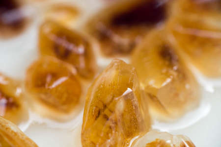 brown rock candy in rum closeup
