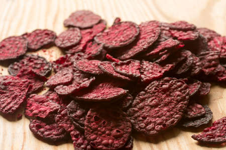 purple baked beet chips closeup on wooden backgroundの写真素材