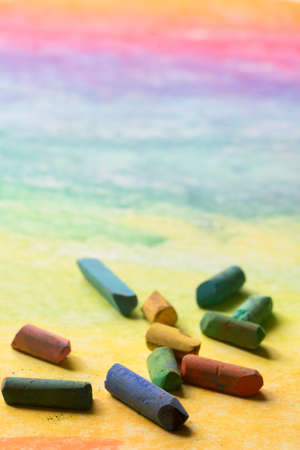 pastel crayons on multicolored paper background closeupの写真素材