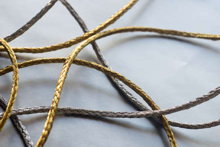 silver and gold twine on silver paper background
