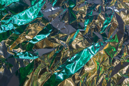 multicolored color creased metallic foil abstract bacgkgroundの写真素材