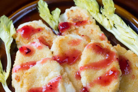 fried mozzarella cheese with cranberry jam on plateの写真素材