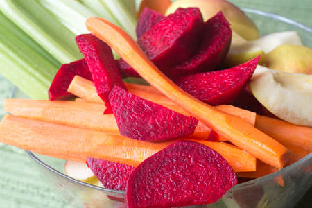 group of raw vegetables and fruits in glass bowlの写真素材