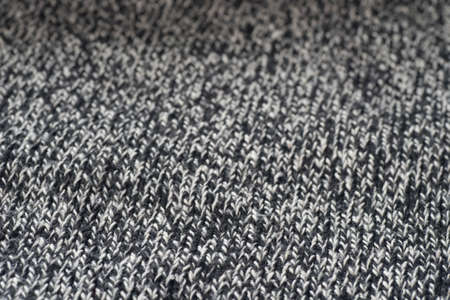 gray knitwear woolen textile texture background  macro selective focus