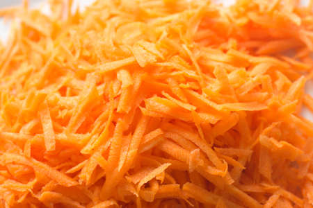 raw grated carrot on plateの写真素材