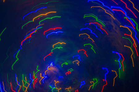 multicolored motion blurred lights in dark patternの写真素材