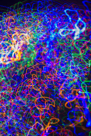multicolored motion blurred lights in dark pattern