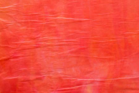 red color creased tissue paper bacground textureの写真素材