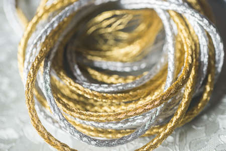 silver and gold twine on silverbackground macroの写真素材
