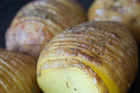 sliced baked in oven potatoes with herbsの写真素材