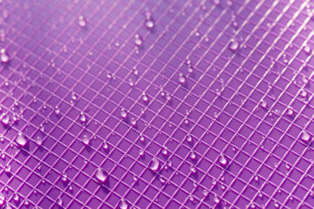 water drops on violet color plastic background textureの写真素材