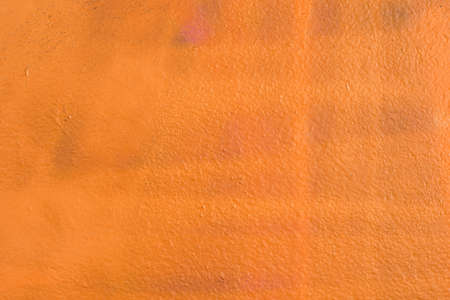 orange color painted wall texture backgroundの写真素材