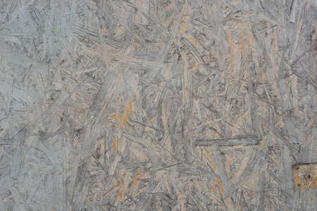 old weathered painted wooden oriented strand board (OSB) background texture