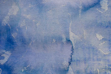 watercolor blue color painted on paper background textureの写真素材