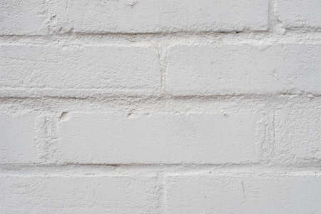white painted brick wall background texture closeupの写真素材