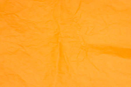 orange color creased tissue paper background textureの写真素材