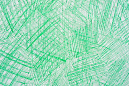 green color crayon drawings on  paper background textureの写真素材