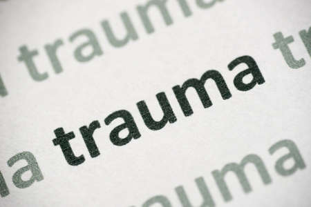 word trauma printed on white paper macroの写真素材