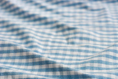 folded blue and white checkered fabric background textureの写真素材