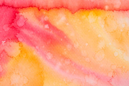 Multicolored watercolor ink painted on paper background texture macroの写真素材