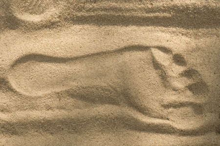 Foot print on sand backgroundの写真素材