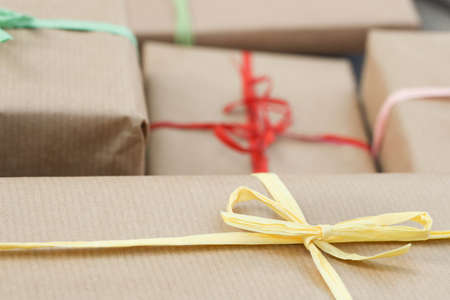 gift boxes wrapped in recycled paper with color bows for Christmas macro