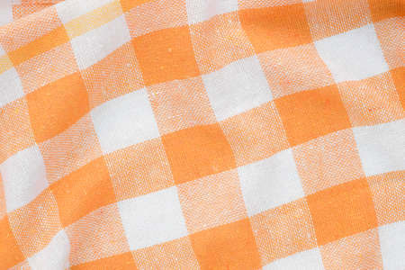 orange and white checkered creased  kitchen towel background texture