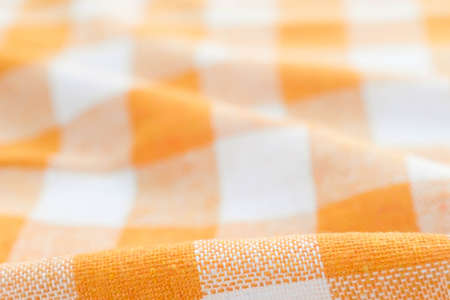 orange and white checkered creased  kitchen towel background textureの写真素材