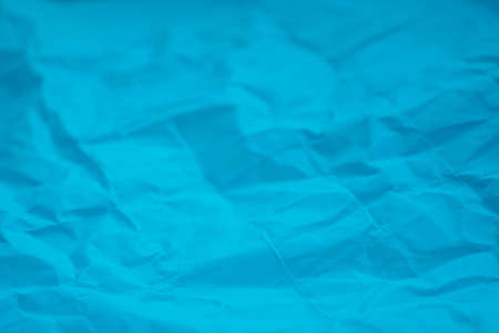 blue color creased paper background texture selective focusの写真素材