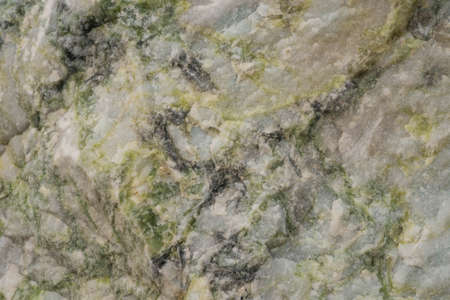 rough granite stone covered with hoarfrost