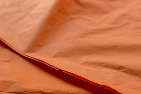 orange color creased paper tissue background textureの写真素材