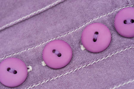 violet buttons - detail of dress macroの写真素材