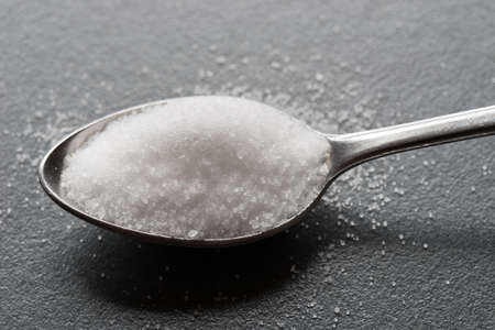 spoon of salt on table macro