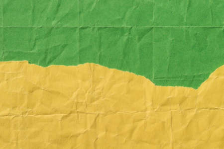 pieces of creased yellow and green colors paper  background textureの写真素材