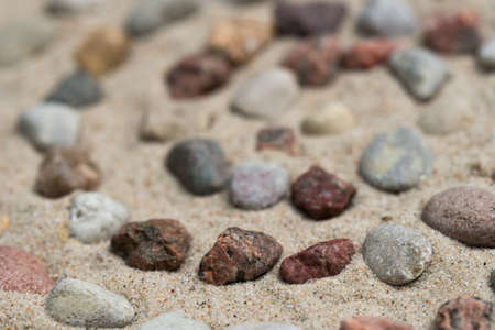 spiral pattern made of pebbes on sand background