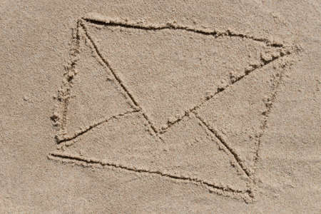 envrelope - drawing on sand backgroundの写真素材