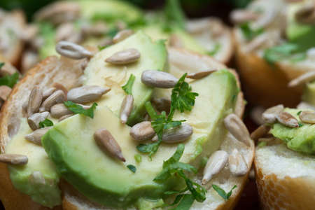 vegan small sandwiches with avocado, parsley and sunflower seeds macro